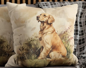 May include: Two square throw pillows featuring a watercolor-style illustration of a golden retriever sitting in a grassy field. The dogs are depicted in profile with light brown fur against a soft, muted beige and green background.