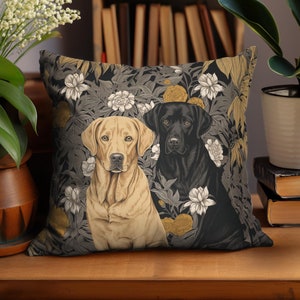 May include: A decorative throw pillow with a floral pattern featuring two dogs, one black and one light brown, against a dark background.