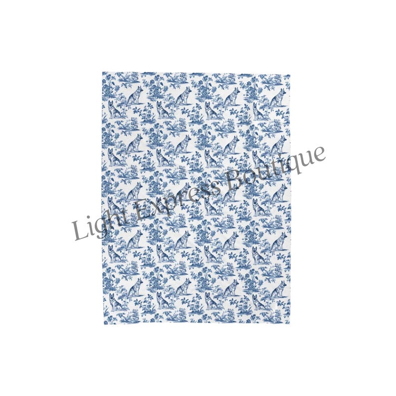 May include: A white and blue patterned blanket featuring a repeating design of dogs and floral elements. The design is reminiscent of classic toile patterns, with a detailed illustration of dogs in a natural setting.