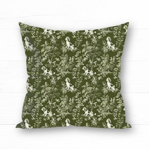 May include: A green throw pillow with a repeating pattern of white dogs and foliage. The dogs are in a seated position and the foliage is stylized.