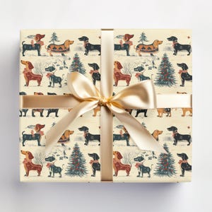 May include: Cream-coloured gift wrap with a repeating pattern of dachshunds wearing festive attire and Christmas trees. The dachshunds are brown, black, and white with red, green, and blue accents. The gift wrap is tied with a gold ribbon.