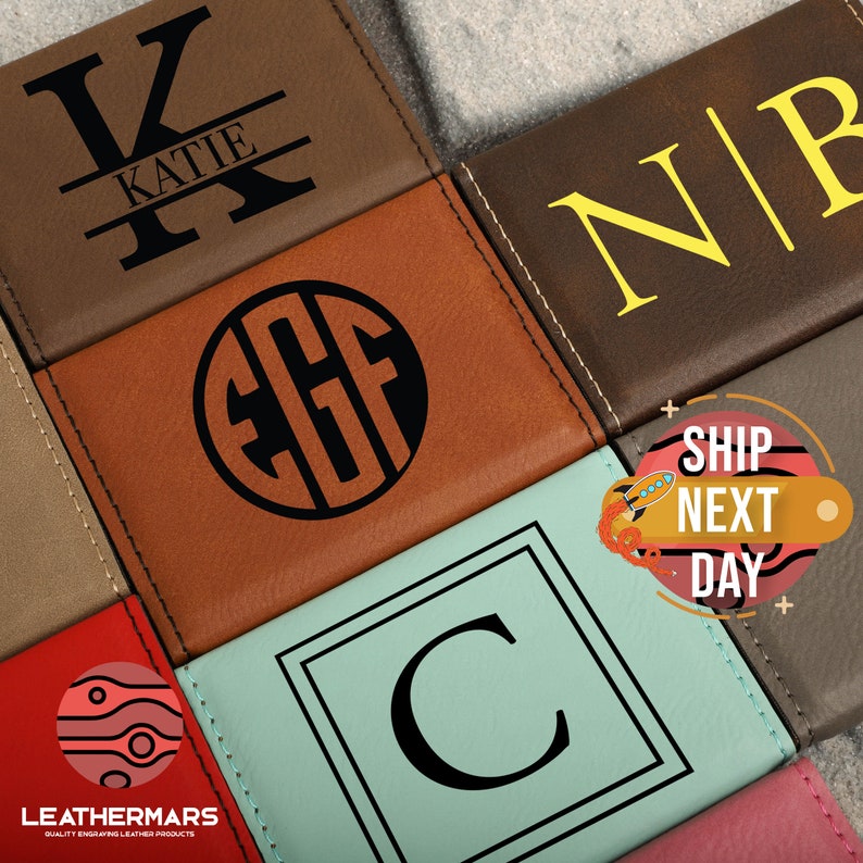May include: A close-up of several personalized leather wallets with different monogram styles. The wallets are in various colors, including brown, tan, blue, and red. The monograms are in black and yellow. The text "SHIP NEXT DAY" is visible in the image.
