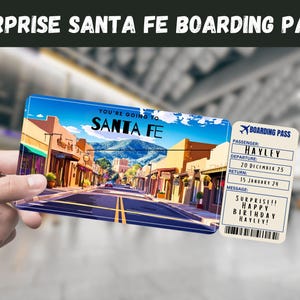 May include: A surprise Santa Fe boarding pass with the text "YOU'RE GOING TO SANTA FE" over a street scene. A smaller boarding pass shows "HAYLEY" as the passenger, with departure and return dates, and a birthday message.