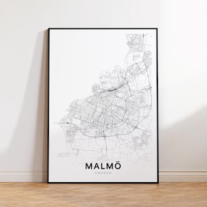 May include: A framed black and white map print of Malmö, Sweden. The map details the city's streets and infrastructure. The city name and country are printed in a bold, sans-serif font at the bottom of the print.