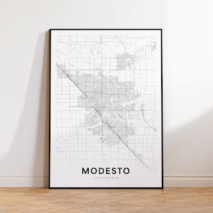 May include: Black and white line art map print of Modesto, California. The map shows the city streets and surrounding area.