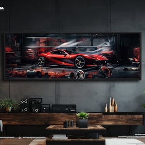 Può includere: Una fotografia incorniciata di una Ferrari rossa in un garage. L'auto è a fuoco, con lo sfondo del garage sfocato. La cornice è nera e appesa a un muro di cemento grigio.
