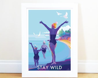 May include: A colorful illustration of three women in swimsuits and hats, standing in the ocean with their arms raised. The text "STAY WILD" is printed below the women. The background is a blue sky with white birds flying.
