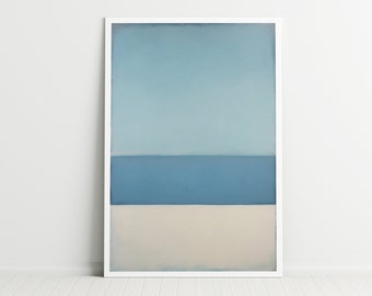 May include: A framed abstract art print featuring three horizontal bands of color. The top band is a light blue, the middle is a darker blue, and the bottom is a beige color. The artwork is displayed in a white frame.