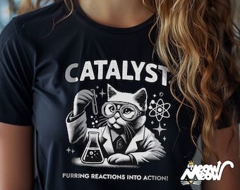 May include: Black t-shirt with a white illustration of a cat wearing a lab coat and holding a test tube. The text "CATALYST" is above the cat and "PURRING REACTIONS INTO ACTION!" is below the cat.