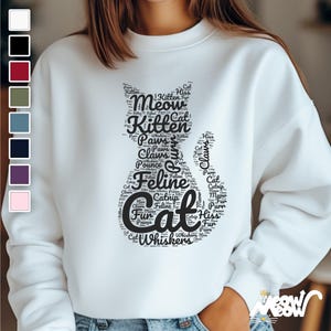 May include: White sweatshirt with a black cat silhouette made of words related to cats, such as "meow", "kitten", "paws", "claws", "feline", and "whiskers".