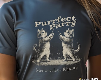 May include: A dark blue t-shirt with a graphic of two cats fencing with the text "Purrfect Parry" and "Meow-velous Riposte".