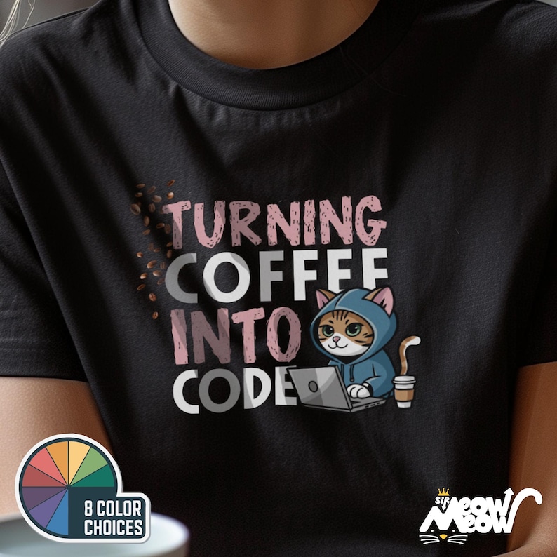 May include: Black t-shirt with the text "Turning Coffee Into Code" in pink and white. A cartoon cat wearing a pink and blue hoodie is using a laptop. The cat is holding a cup of coffee.
