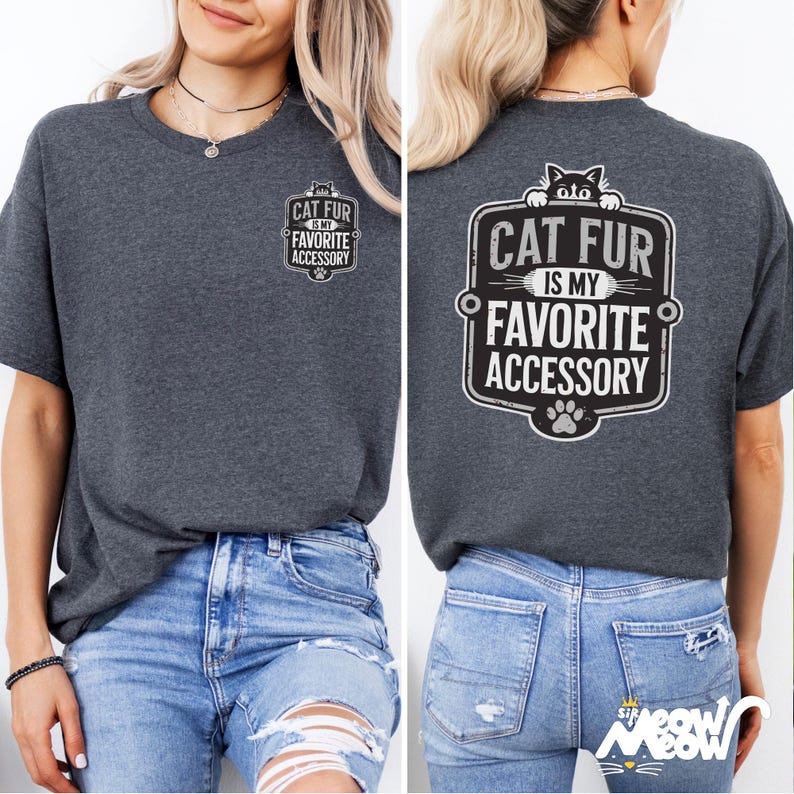 May include: A dark gray t-shirt with a black and white graphic on the front that says "Cat fur is my favorite accessory" and a larger graphic on the back that says "Cat fur is my favorite accessory" with a paw print below it.