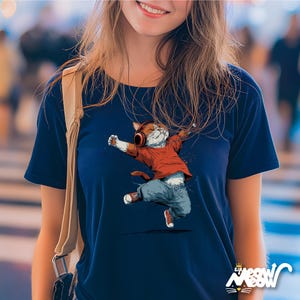 May include: Navy blue t-shirt featuring a dancing cat wearing headphones, a red shirt, blue jeans, and red sneakers. The cat illustration has its arms outstretched. The shirt has the text "Sip Meow Meow" at the bottom.