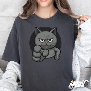 May include: Dark gray t-shirt featuring a cartoon cat with an angry expression, extending a paw. The cat is gray with a black outline, set against a black circle. The shirt has the text "Sif Meow Meow" at the bottom.
