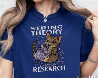 May include: A navy blue t-shirt with a graphic of a brown tabby cat playing with a ball of yarn. The text "String Theory Research" is printed on the shirt.