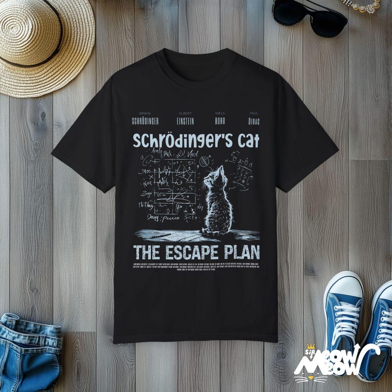 May include: Black t-shirt with a white graphic of a cat looking up at a chalkboard with equations and the text "Schr&ouml;dinger's Cat The Escape Plan".
