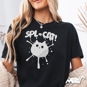 May include: Black t-shirt with a white graphic of a cat splattered in paint. The text "SPL-CAT!" is above the cat.