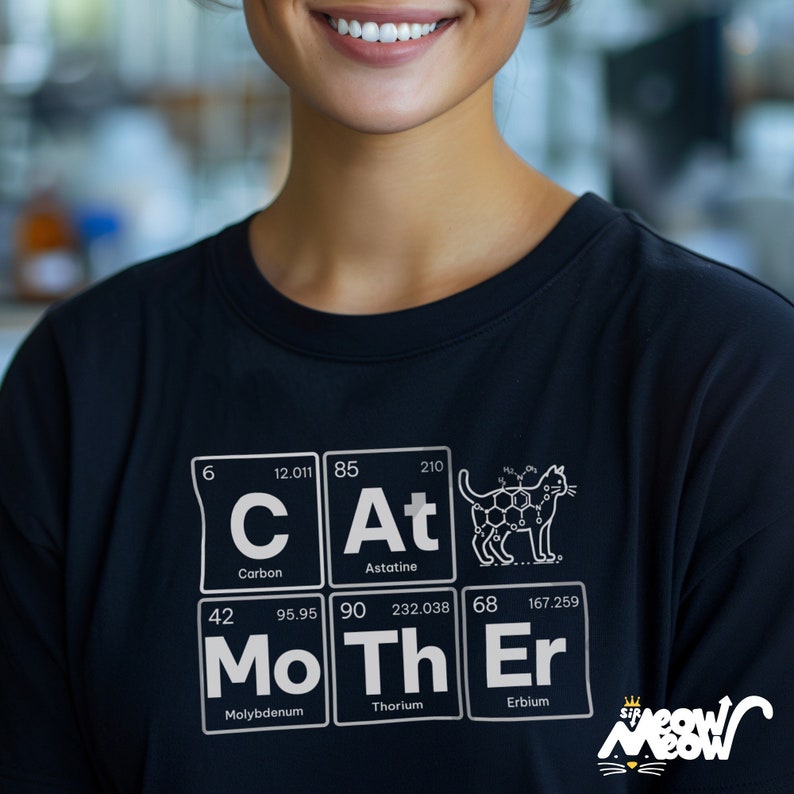 May include: A black t-shirt with a white graphic of the periodic table elements spelling out "CAT MOTHER" with a cat illustration in the "At" element box. The graphic also includes the atomic numbers and weights for each element.
