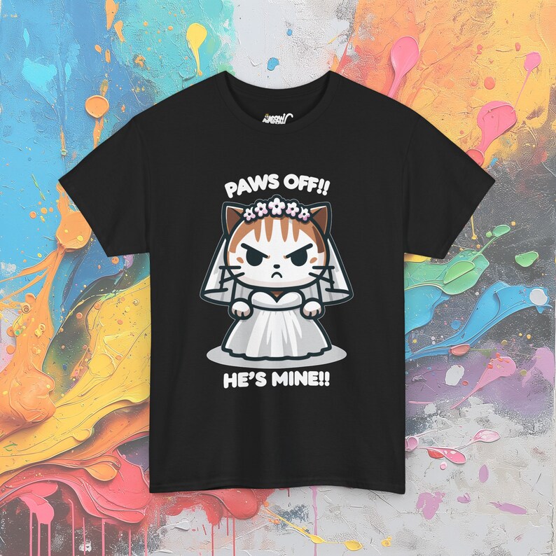 May include: Black t-shirt with a cartoon illustration of a cat wearing a white wedding dress and a flower crown. The text "PAWS OFF!! HE'S MINE!!" is printed below the cat.