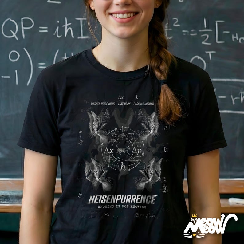 May include: Black t-shirt featuring a graphic with cat faces and scientific symbols. The text includes "HEISENPURRENCE" and "KNOWING IS NOT KNOWING". The shirt also has the names Werner Heisenberg, Max Born, and Pascual Jordan.