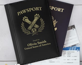 May include: Black "PAWSPORT" passport cover with gold lettering and paw print design. Includes a passport and boarding pass. The passport is personalized with the name "Olivia Smith" and "United States of America".
