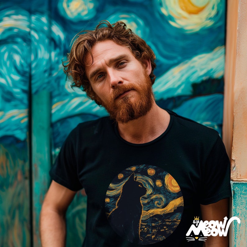 Man who looks like VincentVan Gogh wearing a t-shirt with the illustration of a black cat in a large circle themed as the famous painting "The Starry Night".