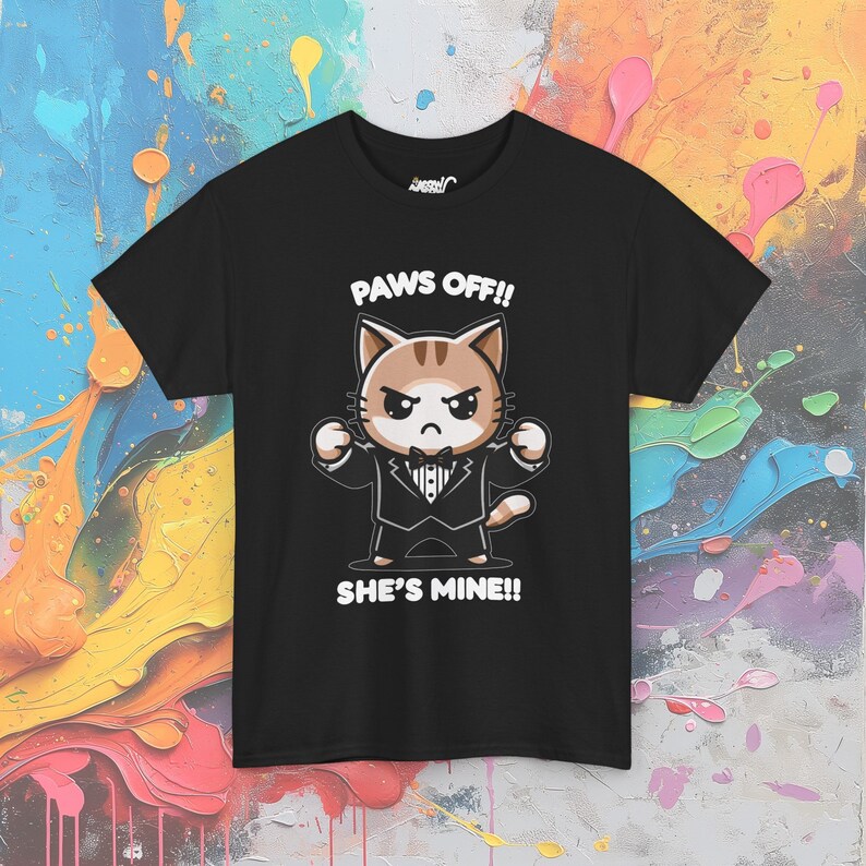 May include: Black t-shirt with a cartoon cat wearing a tuxedo and saying "Paws Off!! She's Mine!!"