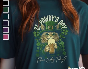 May include: A green t-shirt with a cartoon cat wearing a green hat and holding a beer. The text on the shirt reads "St. Pawdy's Day" and "Feline Lucky Today?"