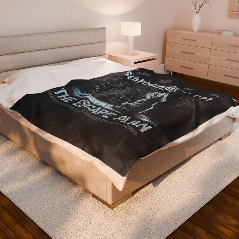May include: A black throw blanket with a white graphic design featuring a cat and the text "Schr&ouml;dinger's cat" and "The Escape Plan".