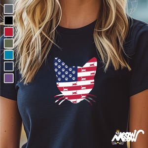 May include: A navy blue t-shirt with a cat silhouette design. The cat's silhouette is filled with the American flag pattern, with paw prints in the blue field. The text "Sir Meow" is printed on the bottom right corner of the shirt.