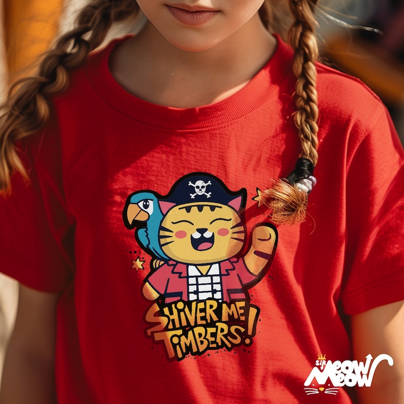 May include: Red t-shirt with a cartoon pirate cat wearing a pirate hat and holding a parrot. The text "Shiver Me Timbers!" is printed on the shirt.