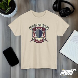 Fencing Cat Society Vintage Style Graphic T-Shirt with Cat Mask and Swords Design Sand