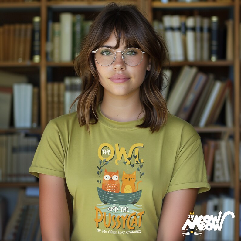 May include: A green t-shirt with a graphic of an owl and a cat in a boat. The text on the shirt reads "The Owl and the Pussycat, The Peg-Leg Boat Adventures".