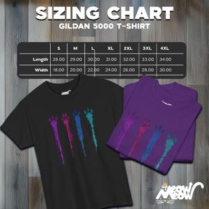 May include: A sizing chart for Gildan 5000 T-shirts with measurements in inches for length and width. The chart shows sizes from S to 4XL. Two t-shirts are shown, one black with a colourful paw print design and one purple with a similar design.