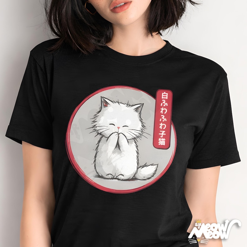 May include: Black t-shirt featuring a white cartoon cat with closed eyes and paws together, inside a red-rimmed circle. Japanese text is on the right. The cat is on a gray background. The shirt has a small logo at the bottom.