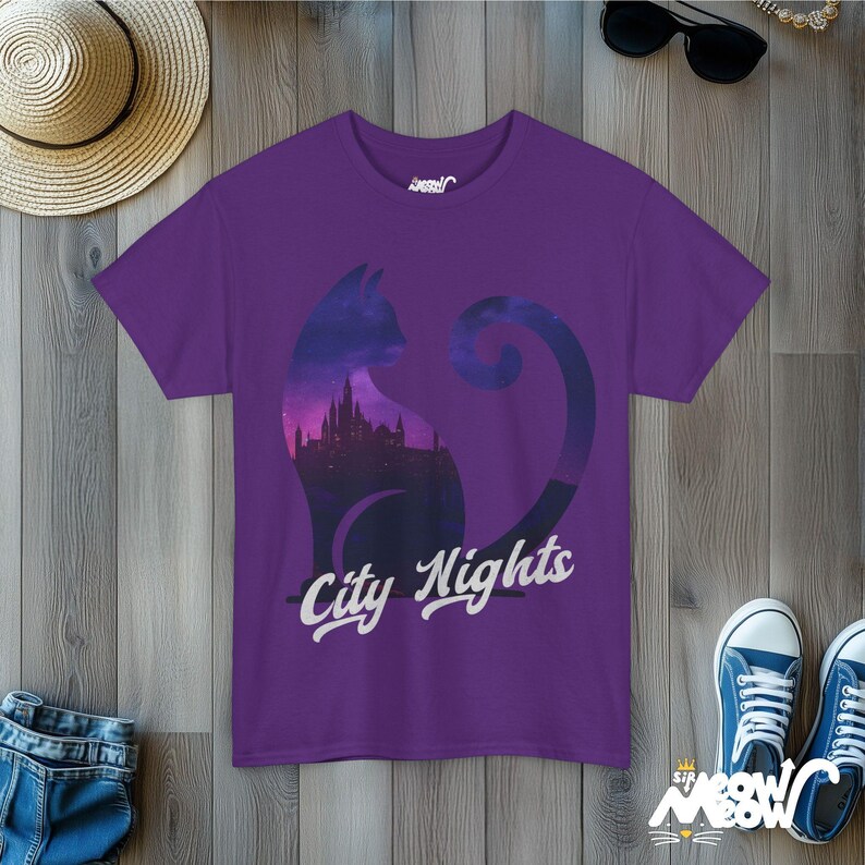 Pode incluir: Camiseta roxa com a silhueta de um gato com um horizonte urbano dentro do seu corpo. O texto "City Nights" est&aacute; impresso abaixo do gato.