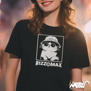 May include: Black t-shirt featuring a white and black graphic of a cat wearing a bucket hat and sunglasses. The text "Rizz to the Max" is below the graphic. The shirt is from the brand "Sir Meow Meow".