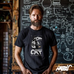 May include: A black t-shirt featuring a white graphic of a cat and a bell. The graphic is a parody of a movie poster and says "Pavlov's Cat" with the tagline "Unlock the mind, unleash the chaos".