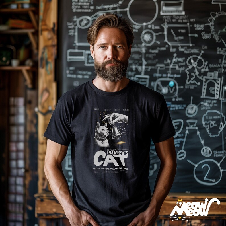 May include: A black t-shirt featuring a white graphic of a cat and a bell. The graphic is a parody of a movie poster and says "Pavlov's Cat" with the tagline "Unlock the mind, unleash the chaos".