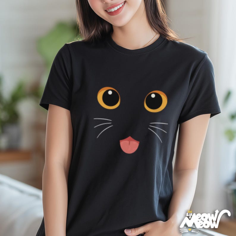 May include: Black t-shirt featuring a cartoon cat face with large yellow eyes, white whiskers, and a pink tongue. The shirt has a crew neck and short sleeves. The text "Sir Meow Meow" is printed at the bottom right corner.