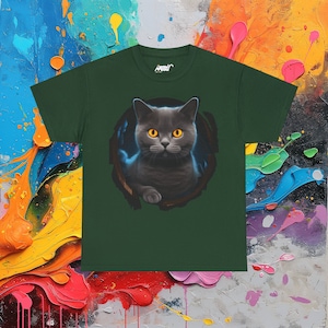 May include: A dark green t-shirt with a graphic of a gray cat with yellow eyes peering out from a hole. The cat is looking directly at the viewer.