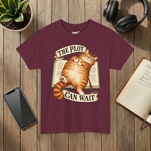 The Plot Can Wait Cat T-Shirt, Ginger Tabby on Book, Book Lover Gift Maroon