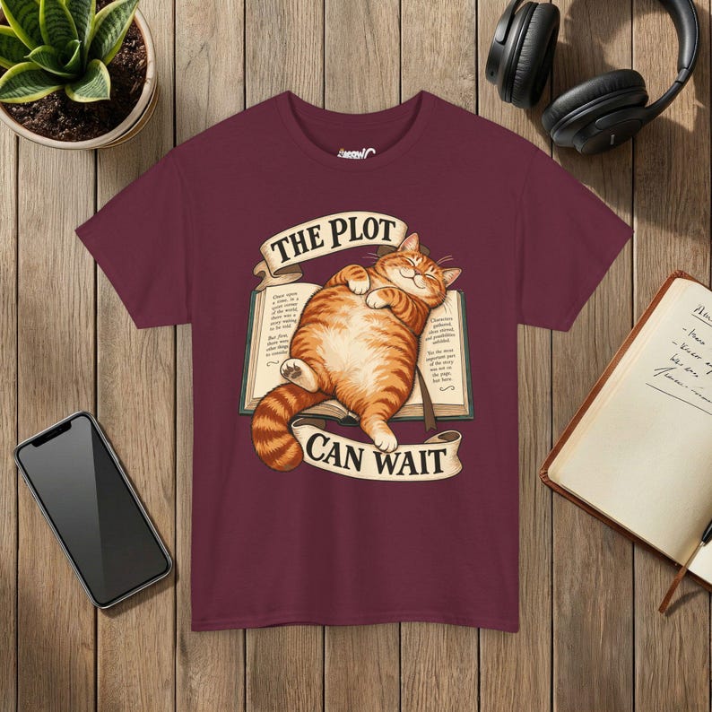 The Plot Can Wait Cat T-Shirt, Ginger Tabby on Book, Book Lover Gift Maroon
