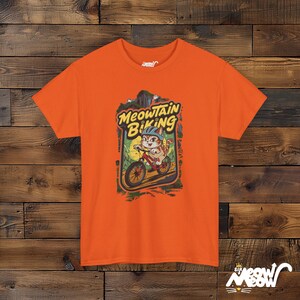 Meowtain Biking T-Shirt: Fun Cat Graphic Tee for Outdoor Lovers Orange
