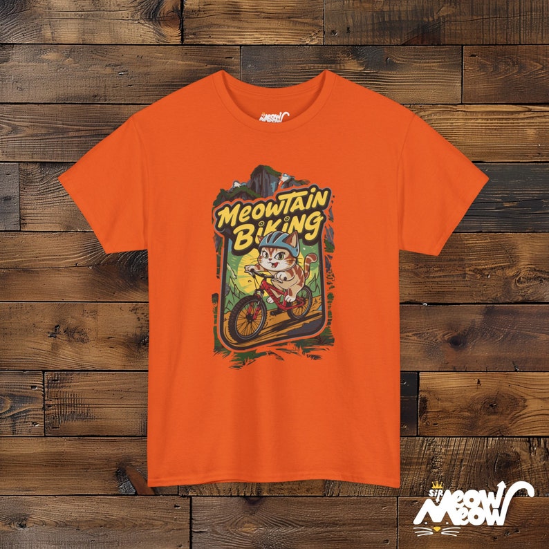 Meowtain Biking T-Shirt: Fun Cat Graphic Tee for Outdoor Lovers Orange