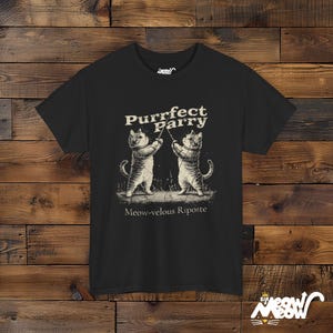 May include: Black t-shirt with a graphic of two cats fencing. The text "Purrfect Parry" is above the cats and "Meow-velous Riposte" is below.