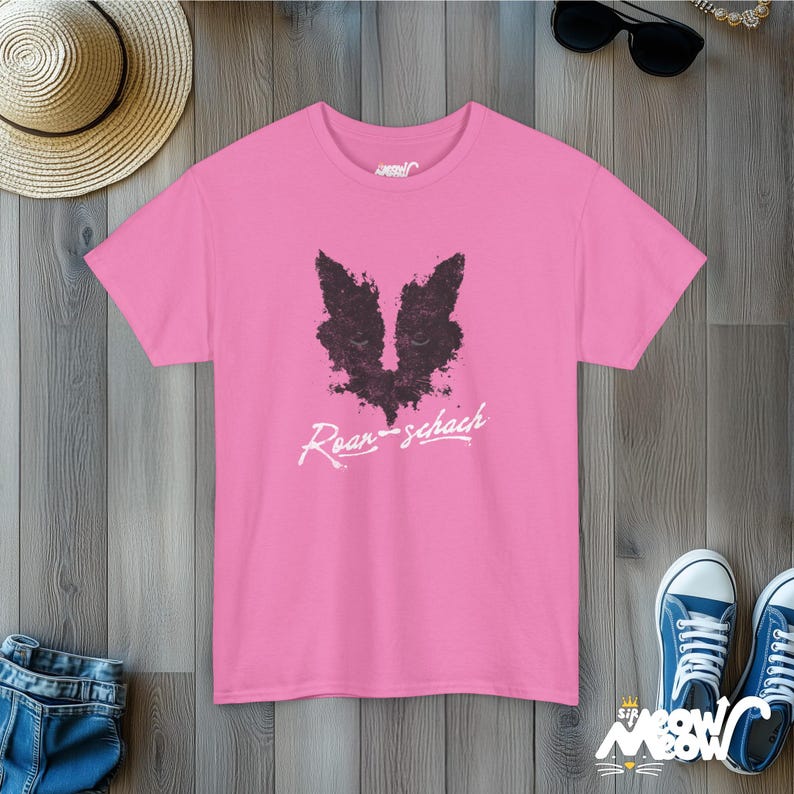May include: Pink t-shirt with a black and white graphic of a fox's face and the text "Roar-schach".