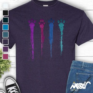 Colorful Paw Prints T-Shirt! Featuring four vibrant paw prints in a stylish paint-splatter style, it’s the ideal way to showcase your passion for pets—no matter the breed or species.
