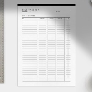 May include: A printable bill tracker sheet with columns for bill name, amount, due date, paid date, and a checkmark for confirmation. The sheet has a black header with the text "BILL TRACKER" and "MONTH".